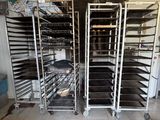 many trays of food that are sitting on a rack