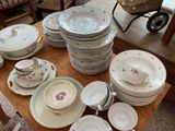 a lot of plates and bowls on the table