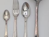 five spoons and two spoons and a spoon with a spoon rest
