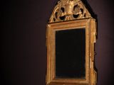 a mirror hanging on the wall in a dark room