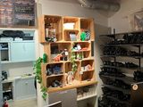 bottles of wine on shelves in a wine shop with a wooden table