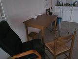 a chair and a table in a room with tile flooring