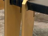 a close up of a wooden table with a black top