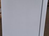 a white refrigerator that is sitting in a warehouse