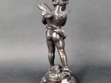 statue of a boy holding a bird on a marble base