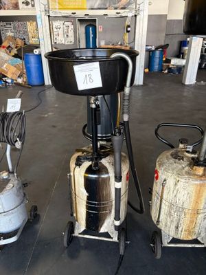 three different machines that are on display in a garage