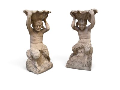 pair of statues of a boy and a girl with a basket on their heads