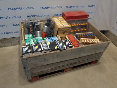 a wooden crate filled with assorted items on the floor