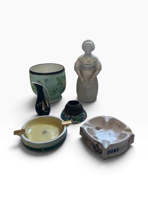 many different types of pottery on a white surface