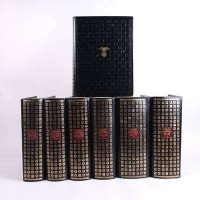 six books are stacked on top of each other on a white surface