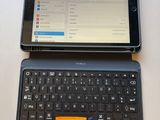 a tablet computer sitting next to a laptop computer on a table