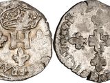 a silver coin with a crown on top of it
