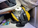 a yellow backpack and a cup sitting on the floor