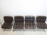 three brown leather chairs sitting next to each other in a room