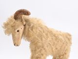 a stuffed animal that is standing on a white surface