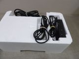 a white box that has a charger and a cord in it