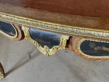 an image of a wooden table with a black and gold top