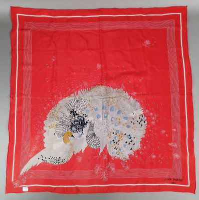 a red scarf with a white and black bird on it