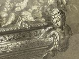 a silver vase with flowers in it on a table