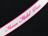 pink and white ribbon with name on it on a mannequin