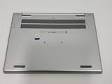 the back of a silver laptop computer sitting on top of a white table