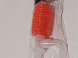 a plastic toothbrush in a plastic bag on a white surface