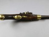 a close up of a wooden and brass pen on a white surface