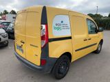 the back end of a yellow van parked in a parking lot