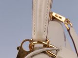 the inside of a white purse with a gold handle