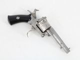 an old silver revolver with a black handle on a white surface