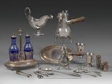 a silver plate and silverware on display on a table