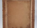 an old picture frame with a piece of paper in it