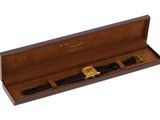 a close up of a watch in a wooden box on a white background