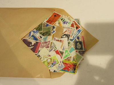 une enveloppe marron sur laquelle sont collés de nombreux timbres