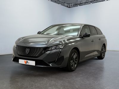 the grey car is parked in a large room with white walls