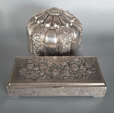 a silver box sitting on a table next to a silver box