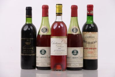 several bottles of wine are lined up on a table