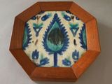 a small wooden box with a blue and white design on it