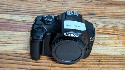 a camera sitting on a wooden table with a lens on it