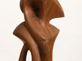 sculpture made of wood on a white pedestal
