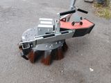 a close up of a street sweeper on the ground