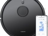 an image of a robot vacuum cleaner with a smartphone next to it