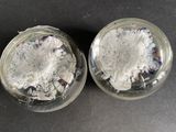 two glass jars filled with different types of paper