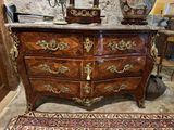 a large chest of drawers in a room with a rug on the floor