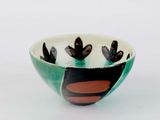 a small bowl with a black and red design on it