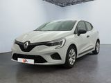 La voiture blanche est garée dans une grande pièce au sol noir.