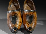 pair of wooden clogs with a heart design on the sole