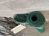 a roll of green wire next to a pile of tools