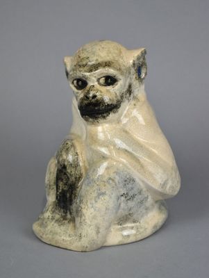 an image of a monkey figurine on a gray background