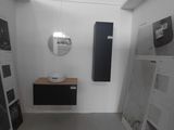 an image of a bathroom with a lot of pictures on the wall